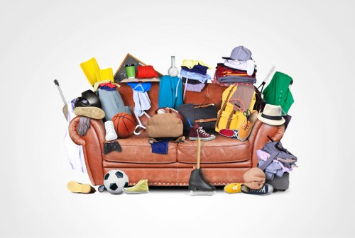 Cluttered garage being organized by professionals